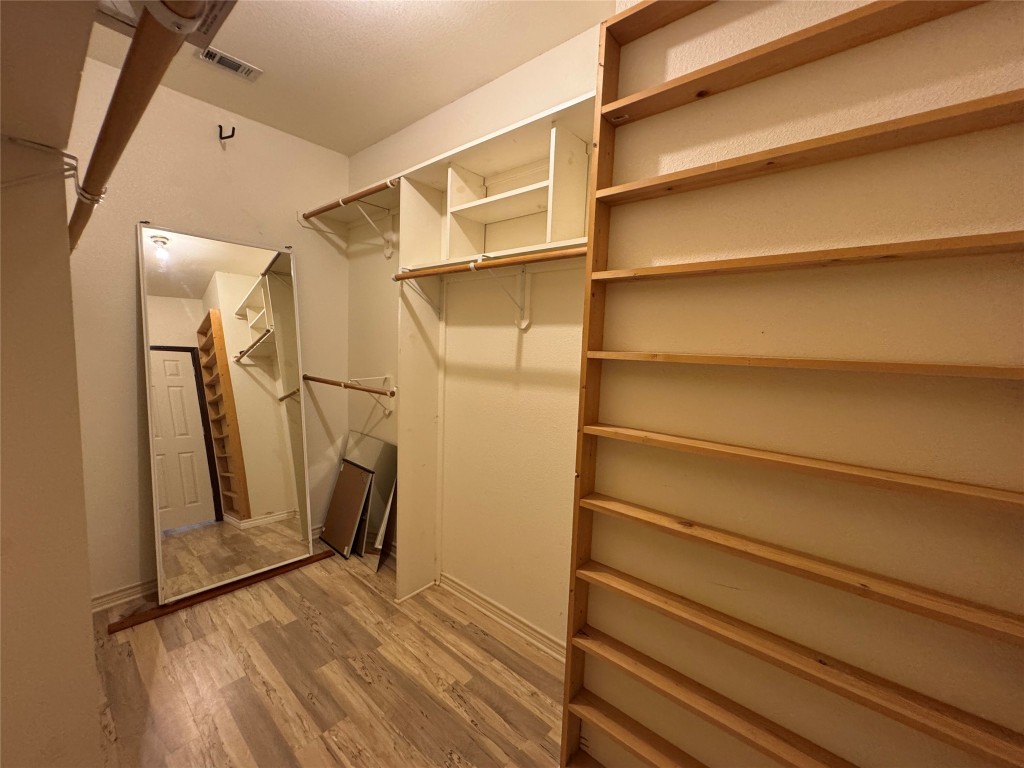 5054 Old Goforth Road Buda, TX 78610 - Photo 17 of 28 a view of walk in closet with empty racks