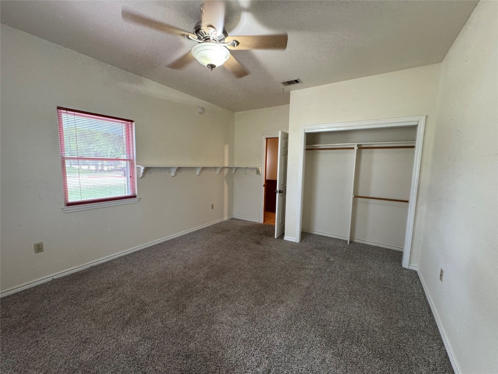 5054 Old Goforth Road Buda, TX 78610 - Photo 20 of 28 a view of empty room with a ceiling fan