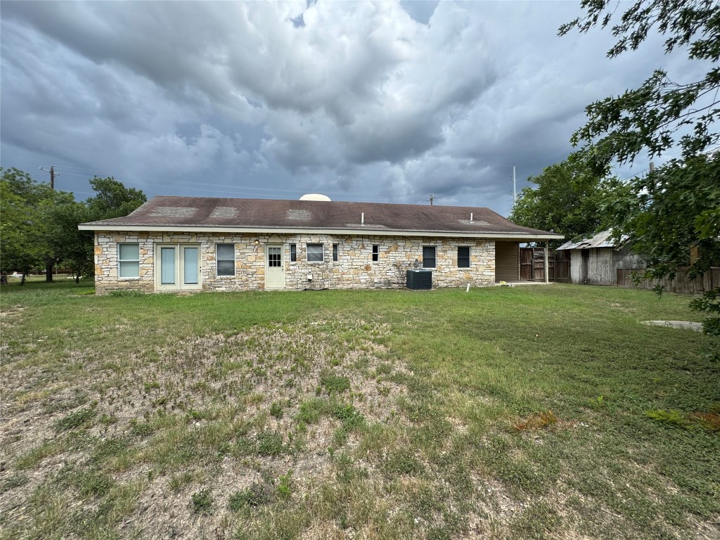 5054 Old Goforth Road Buda, TX 78610 - Photo 24 of 28 a view of house with a big yard and large trees
