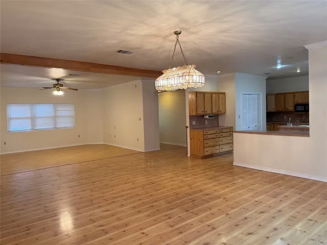 a view of a kitchen with a sink stainless steel appliances and cabinets