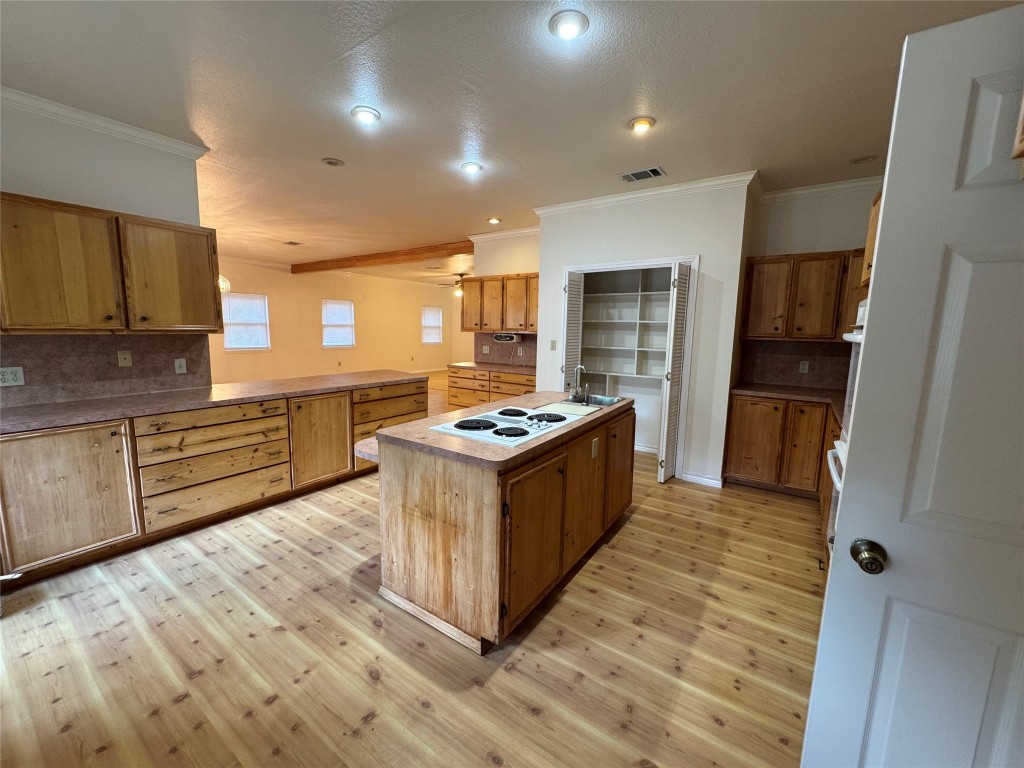 5054 Old Goforth Road Buda, TX 78610 - Photo 7 of 28 a kitchen with stainless steel appliances granite countertop a stove top oven a sink and a refrigerator