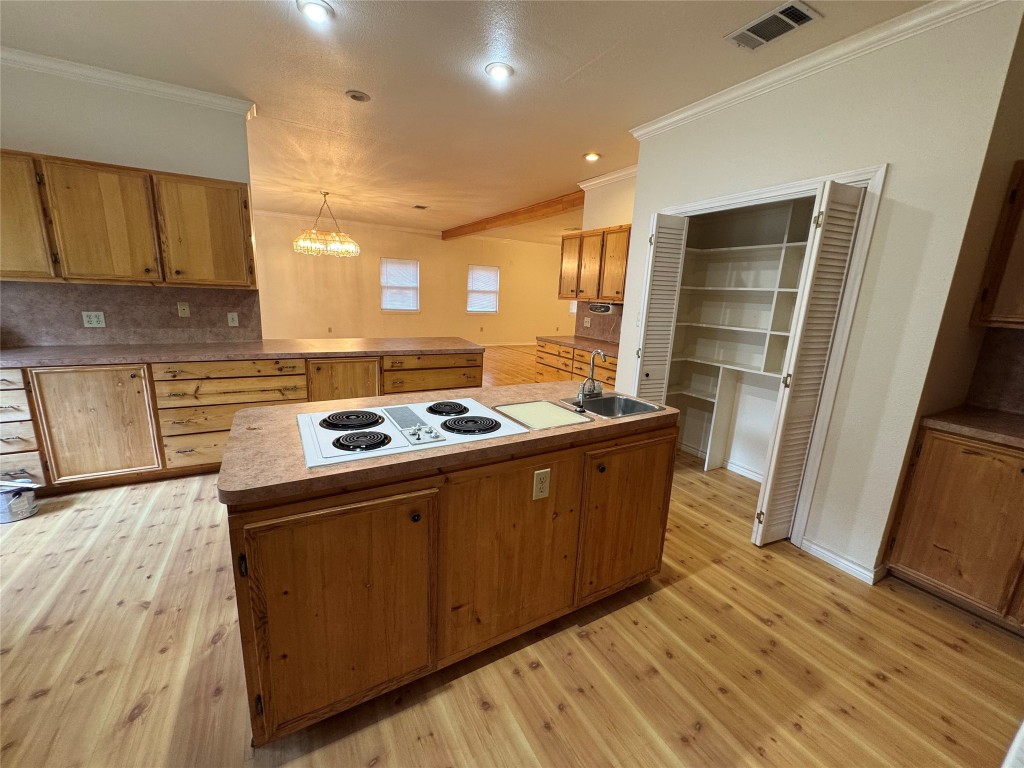 5054 Old Goforth Road Buda, TX 78610 - Photo 8 of 28 a kitchen with wooden cabinets and a stove top oven