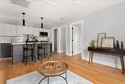 a view of kitchen with furniture and wooden floor