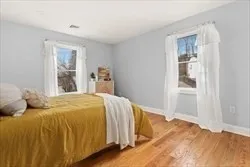 a bed sitting in a bedroom next to a window