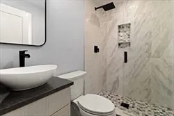 a white toilet sitting next to a bathroom sink