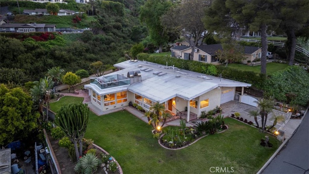an aerial view of a house with garden space and street view