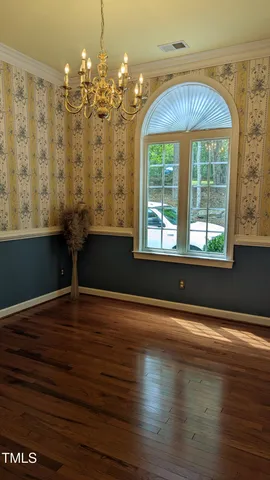 a view of room with window and wooden floor