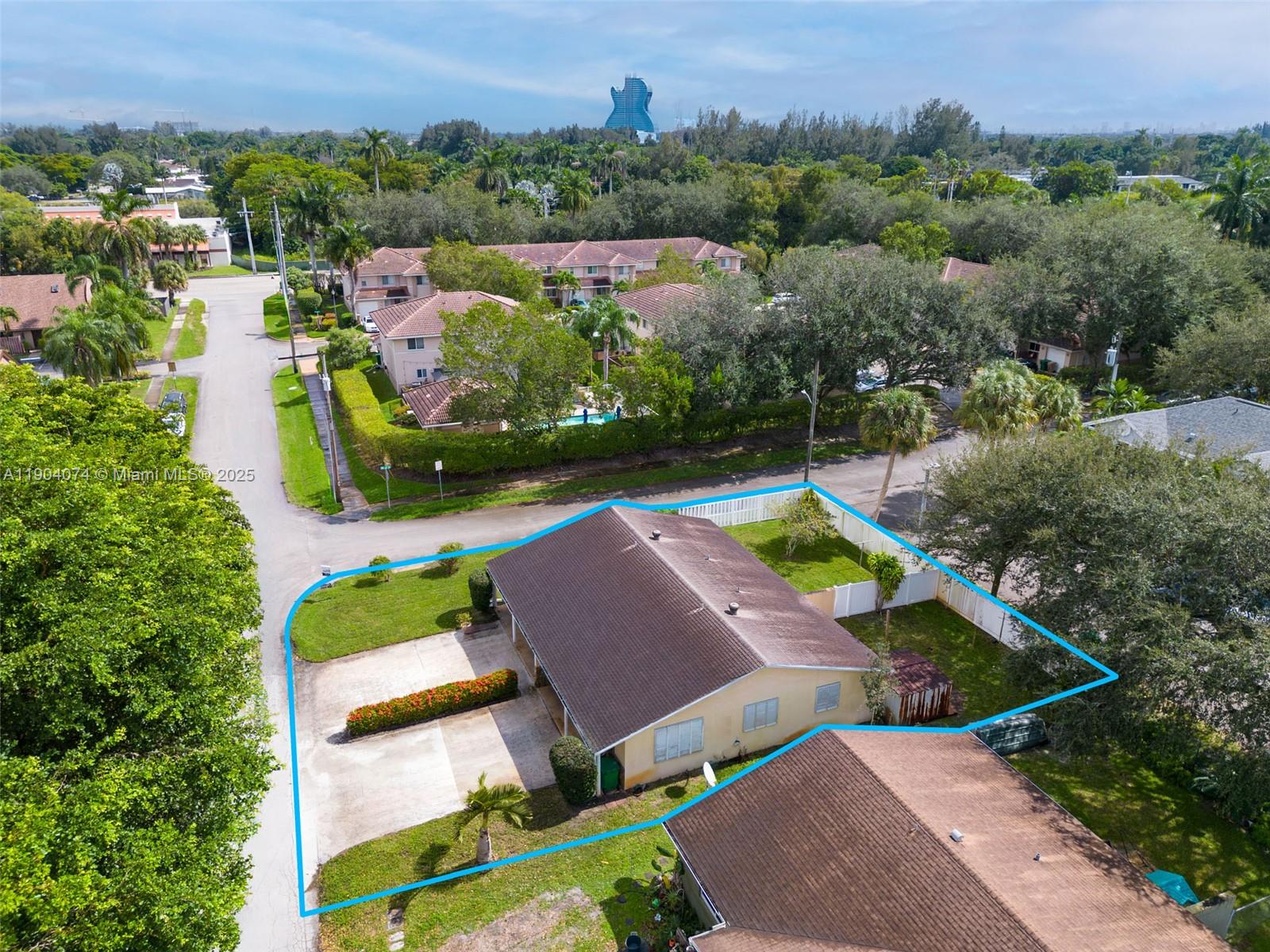 an aerial view of a house with a garden and lake view