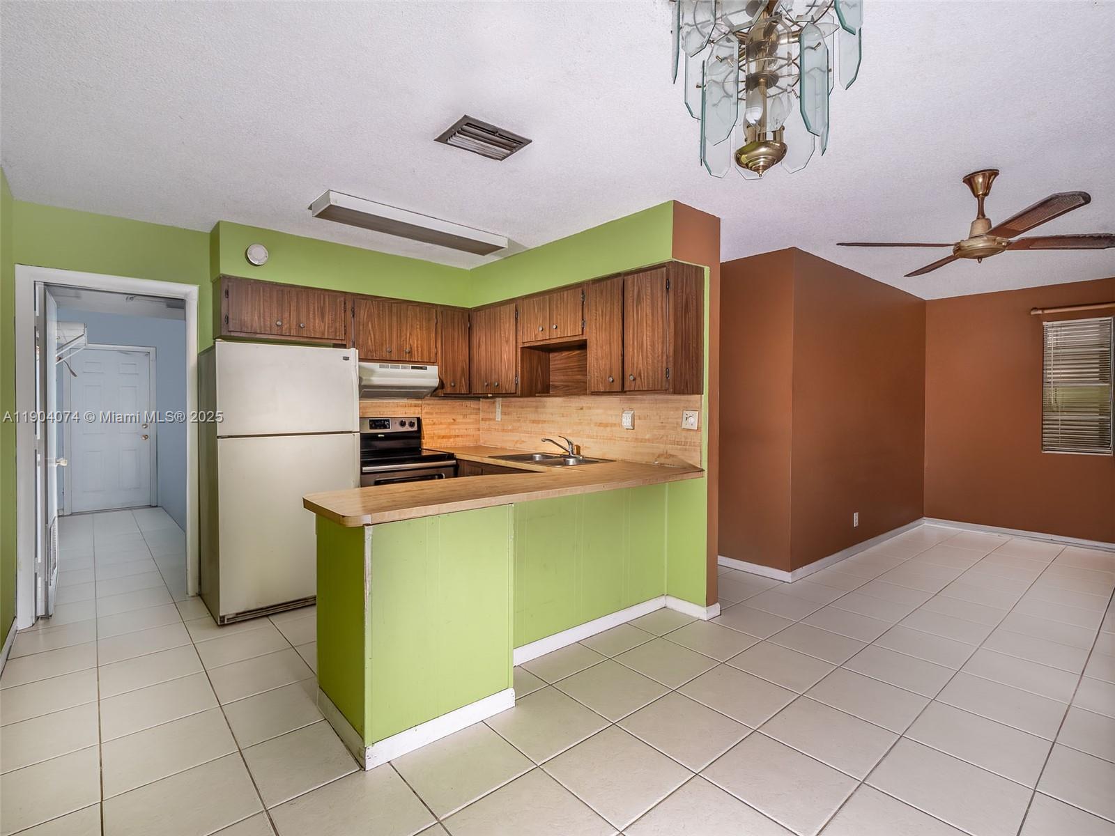 6510 Southwest 49th Street Davie, FL 33314 - Photo 17 of 26 a kitchen with a refrigerator and a sink