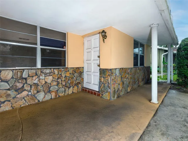 a view of an empty room with wooden floor and a cabinet