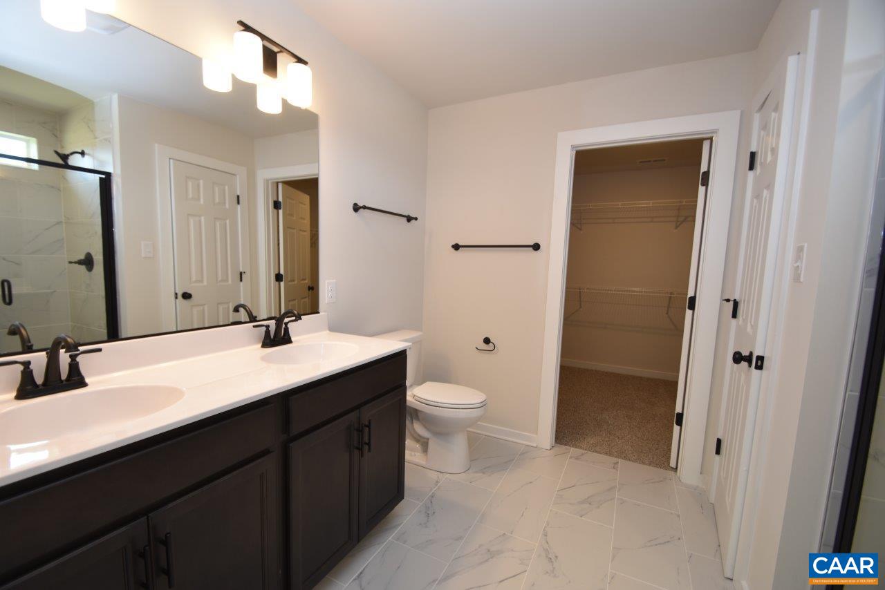 11675 Jack Jouett Road West Zion Crossroads, VA 22942 - Photo 26 of 32 a bathroom with a double vanity sink toilet and mirror