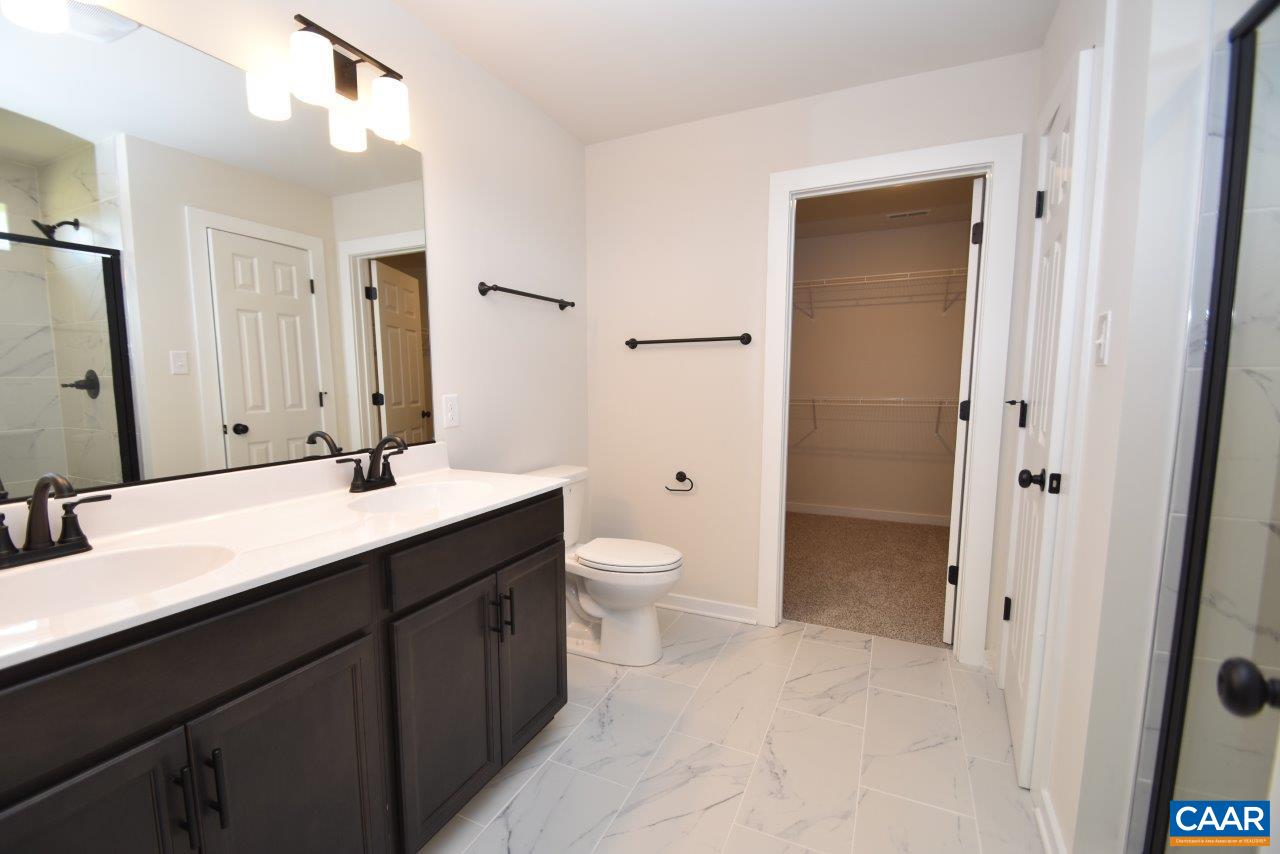 11675 Jack Jouett Road West Zion Crossroads, VA 22942 - Photo 27 of 32 a bathroom with a double vanity sink toilet mirror and shower