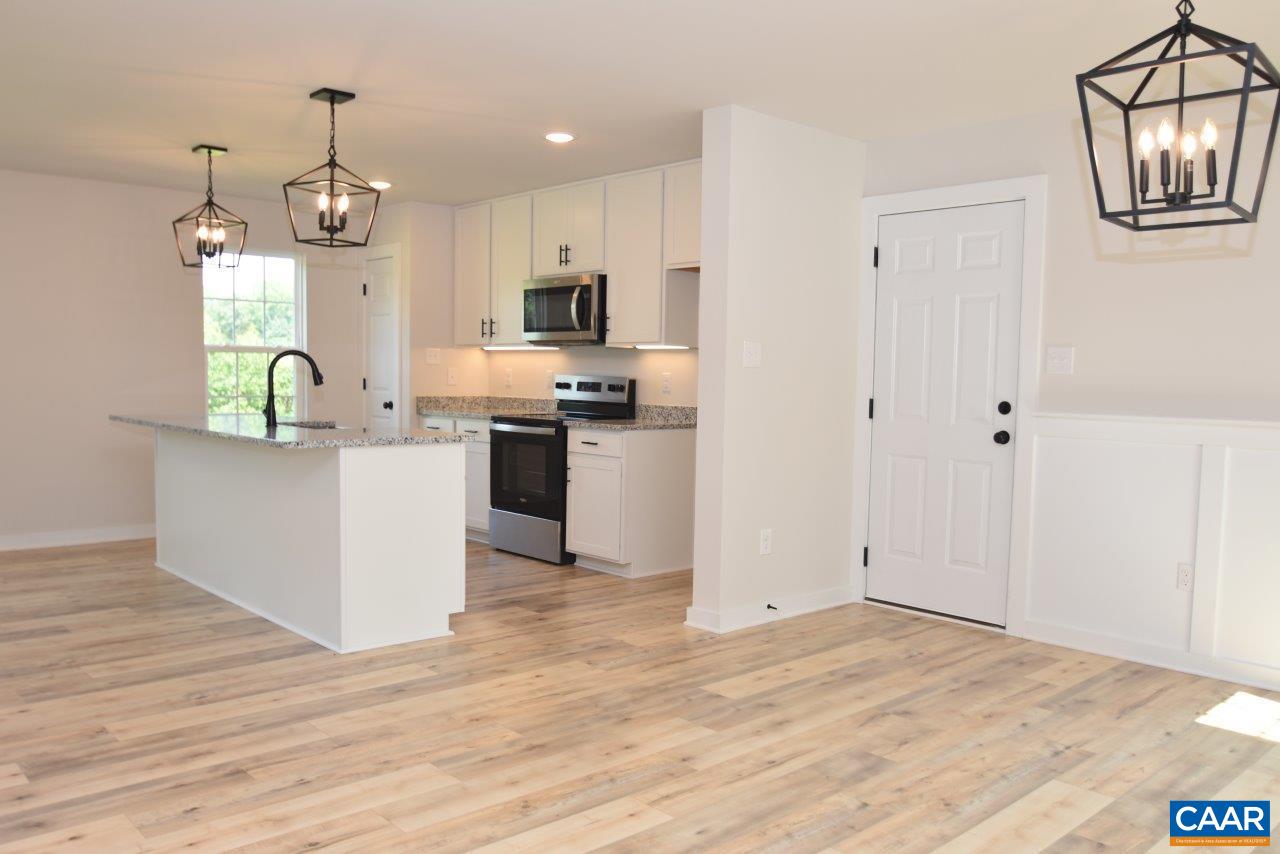 11675 Jack Jouett Road West Zion Crossroads, VA 22942 - Photo 4 of 32 a kitchen view with stainless steel appliances granite countertop a stove top oven a refrigerator a sink and a wooden floor