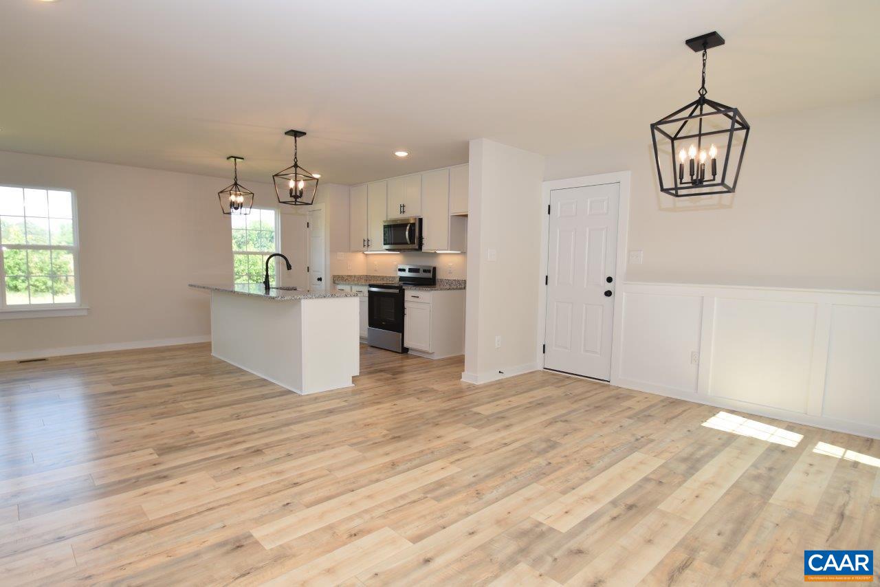 11675 Jack Jouett Road West Zion Crossroads, VA 22942 - Photo 5 of 32 a view of a kitchen with a sink wooden floor and a window