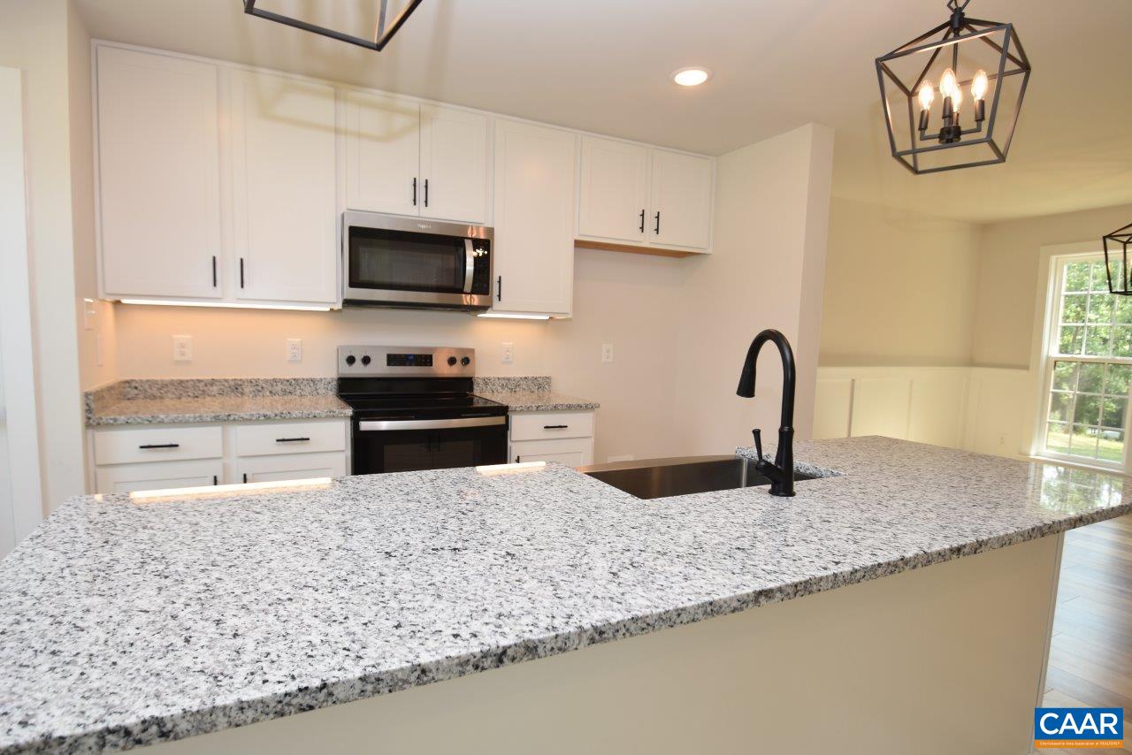 11675 Jack Jouett Road West Zion Crossroads, VA 22942 - Photo 7 of 32 a kitchen with granite countertop a sink a stove and a microwave