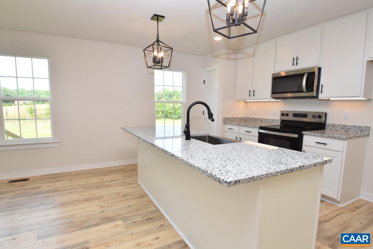 11675 Jack Jouett Road West Zion Crossroads, VA 22942 - Photo 8 of 32 a kitchen with stainless steel appliances granite countertop a sink a stove a microwave oven a counter space and cabinets
