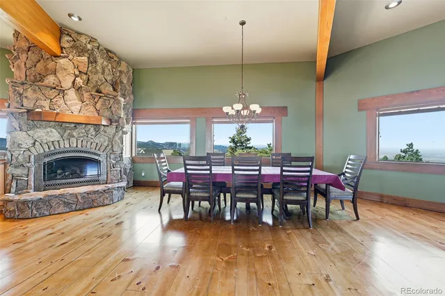 a view of a kitchen with kitchen island stainless steel appliances wooden cabinets and dining table view