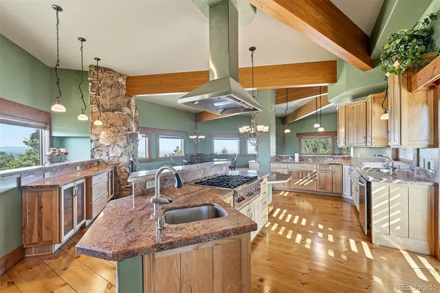 a kitchen with stainless steel appliances granite countertop a sink and cabinets