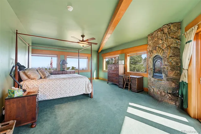 a spacious bathroom with a granite countertop double vanity sink a large mirror and a bathtub