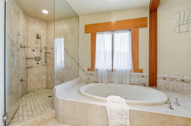a view of a hallway with entryway wooden floor and windows