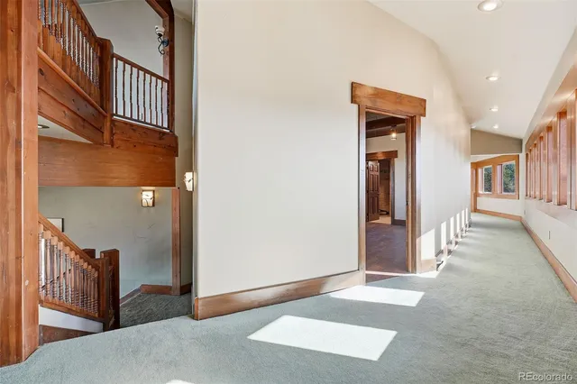 a view of balcony with wooden floor and a garden