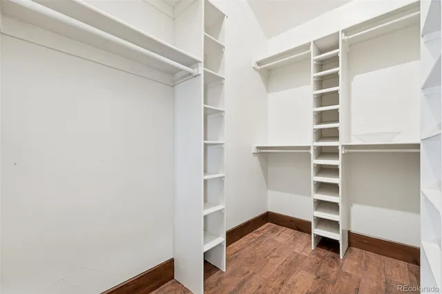 a bathroom with a granite countertop sink a mirror and shower