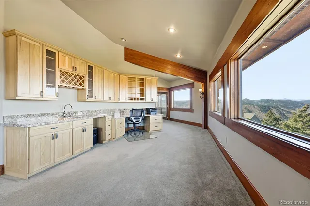 a view of a livingroom with furniture and ceiling fan