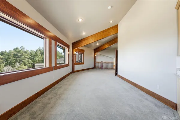 a spacious bedroom with a bed couch and a window