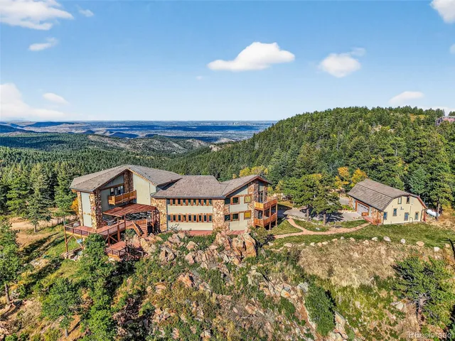 an aerial view of a house with a yard and lake view