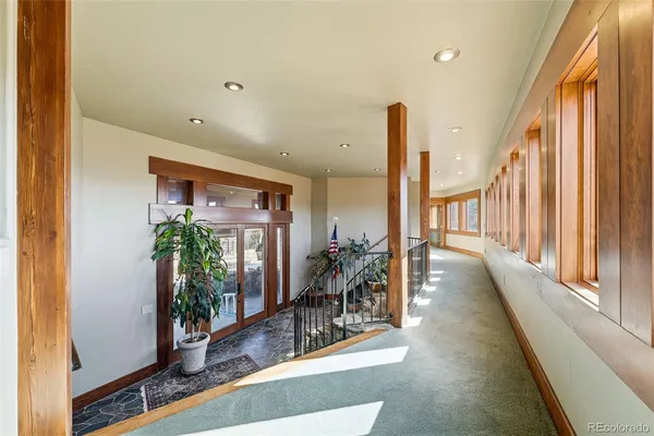 a lobby with furniture and potted plants