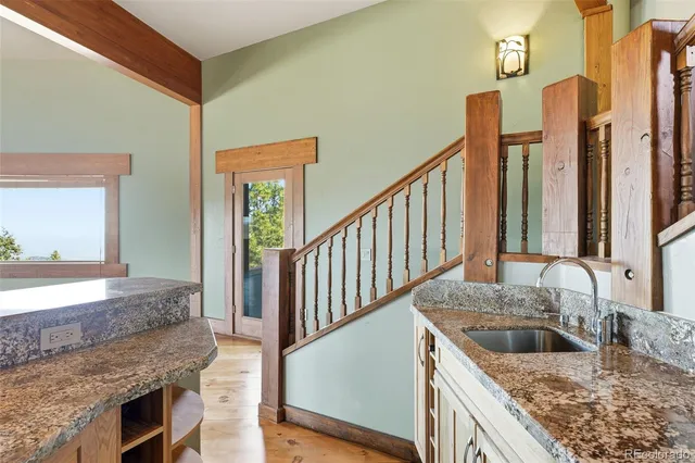 a living room with furniture a fireplace and kitchen view