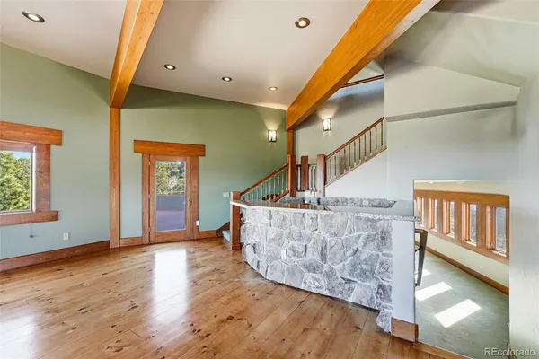 a living room with furniture a fireplace and kitchen view