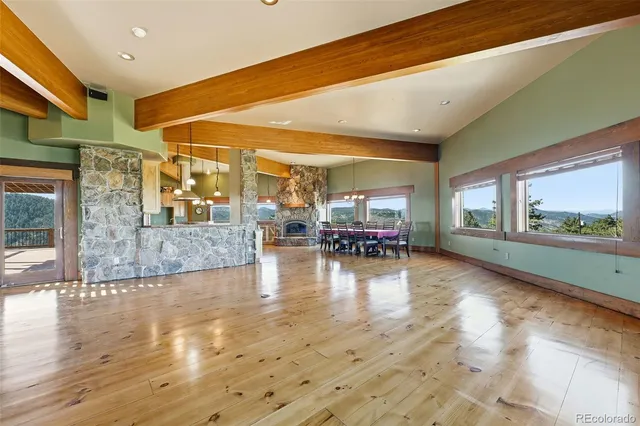 a dining room with furniture a chandelier and wooden floor