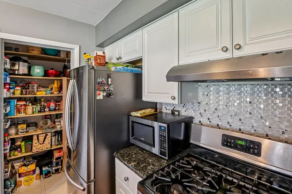 a kitchen with sink refrigerator and large window