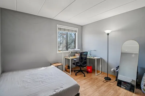 a view of a livingroom with wooden floor and bathroom