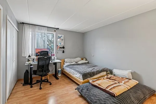 a bedroom with a bed and a table in it