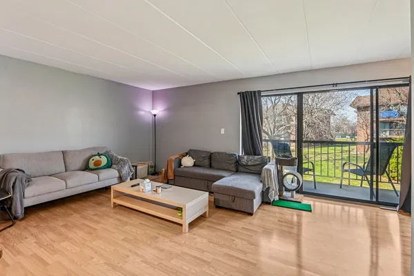 a living room with furniture and a lamp