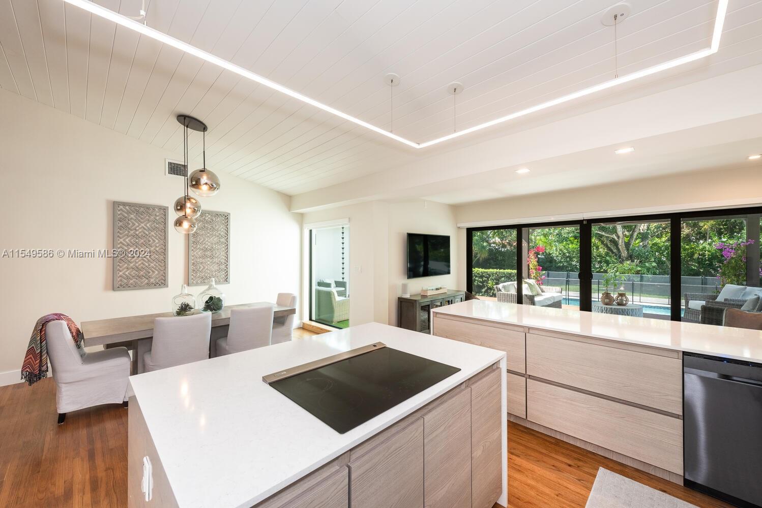 520 Southwest 27th Road Miami, FL 33129 - Photo 12 of 50 a large white kitchen with a large window