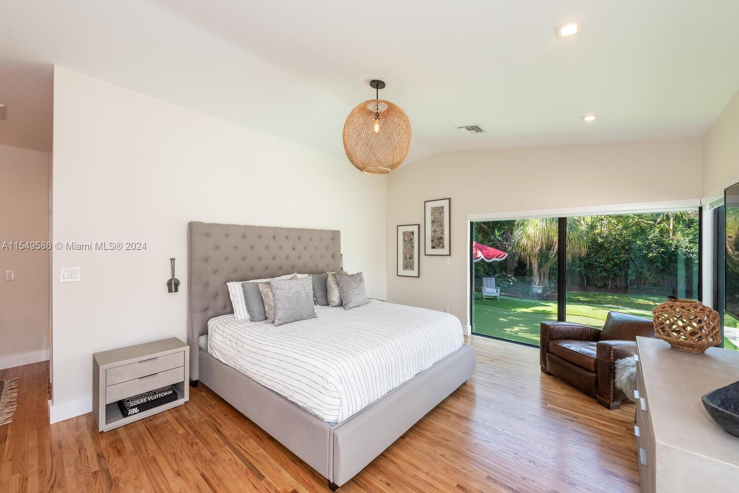 520 Southwest 27th Road Miami, FL 33129 - Photo 17 of 50 a bedroom with a bed and a floor to ceiling window