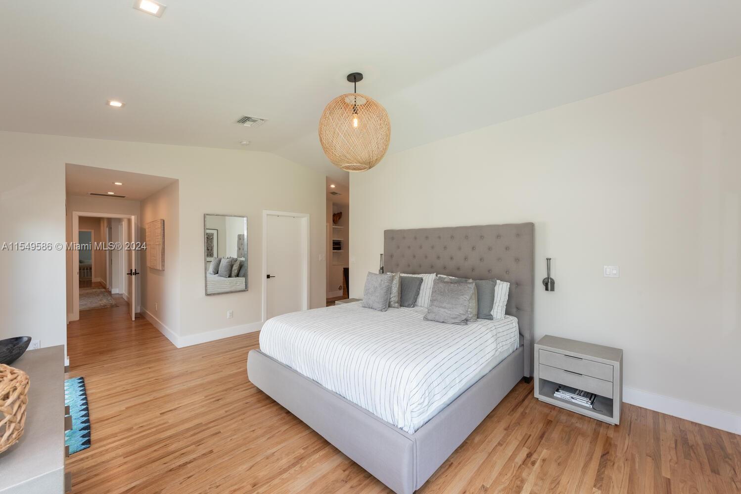 520 Southwest 27th Road Miami, FL 33129 - Photo 18 of 50 a bedroom with a bed and wooden floor