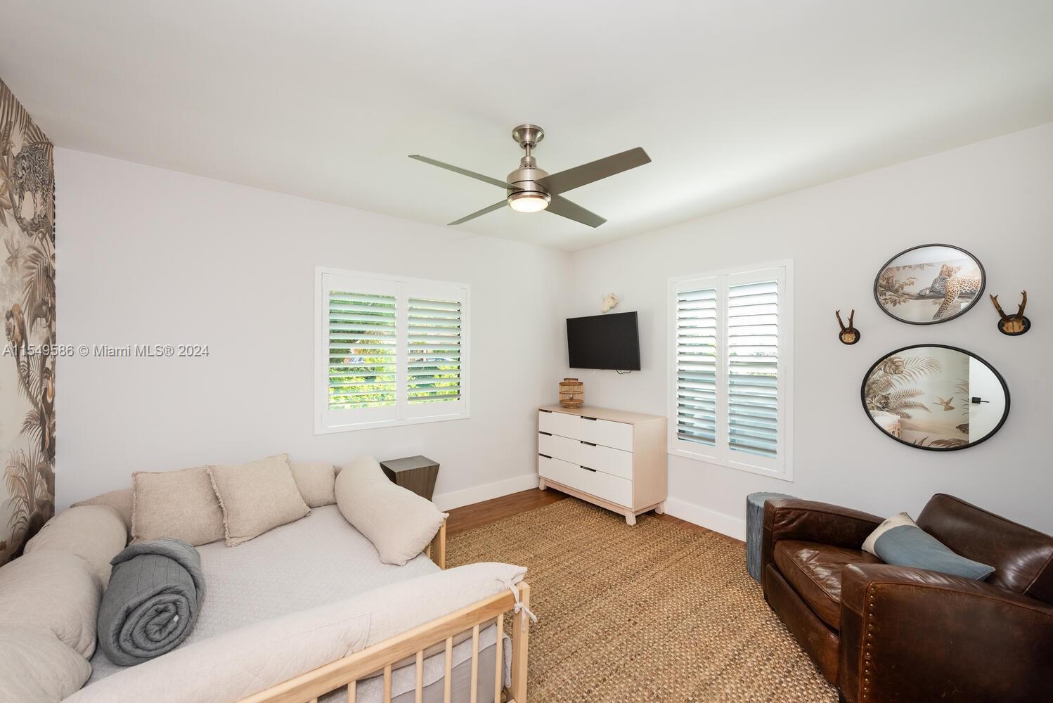520 Southwest 27th Road Miami, FL 33129 - Photo 21 of 50 a living room with furniture a window and a flat screen tv