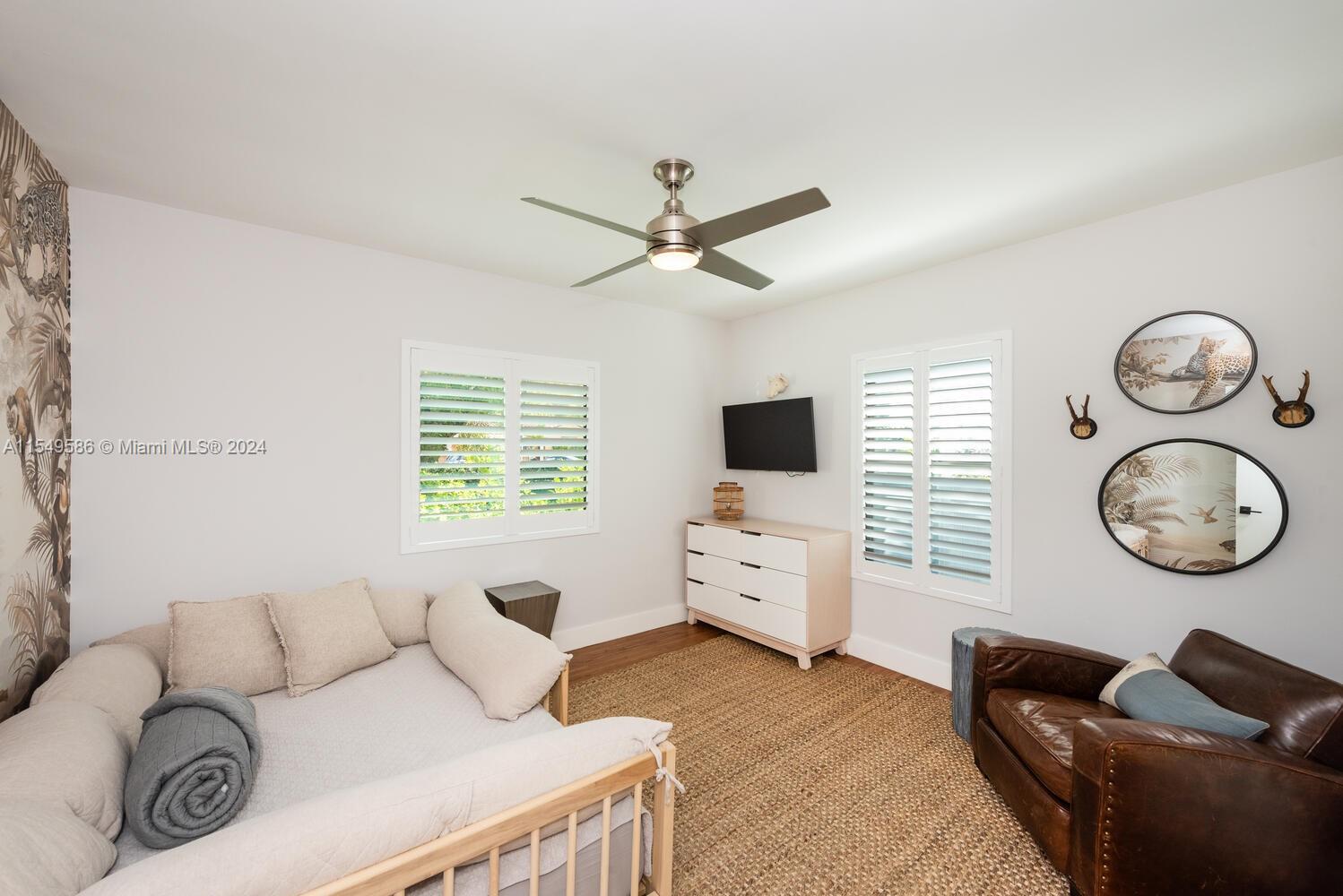 520 Southwest 27th Road Miami, FL 33129 - Photo 22 of 50 a living room with furniture a window and a flat screen tv