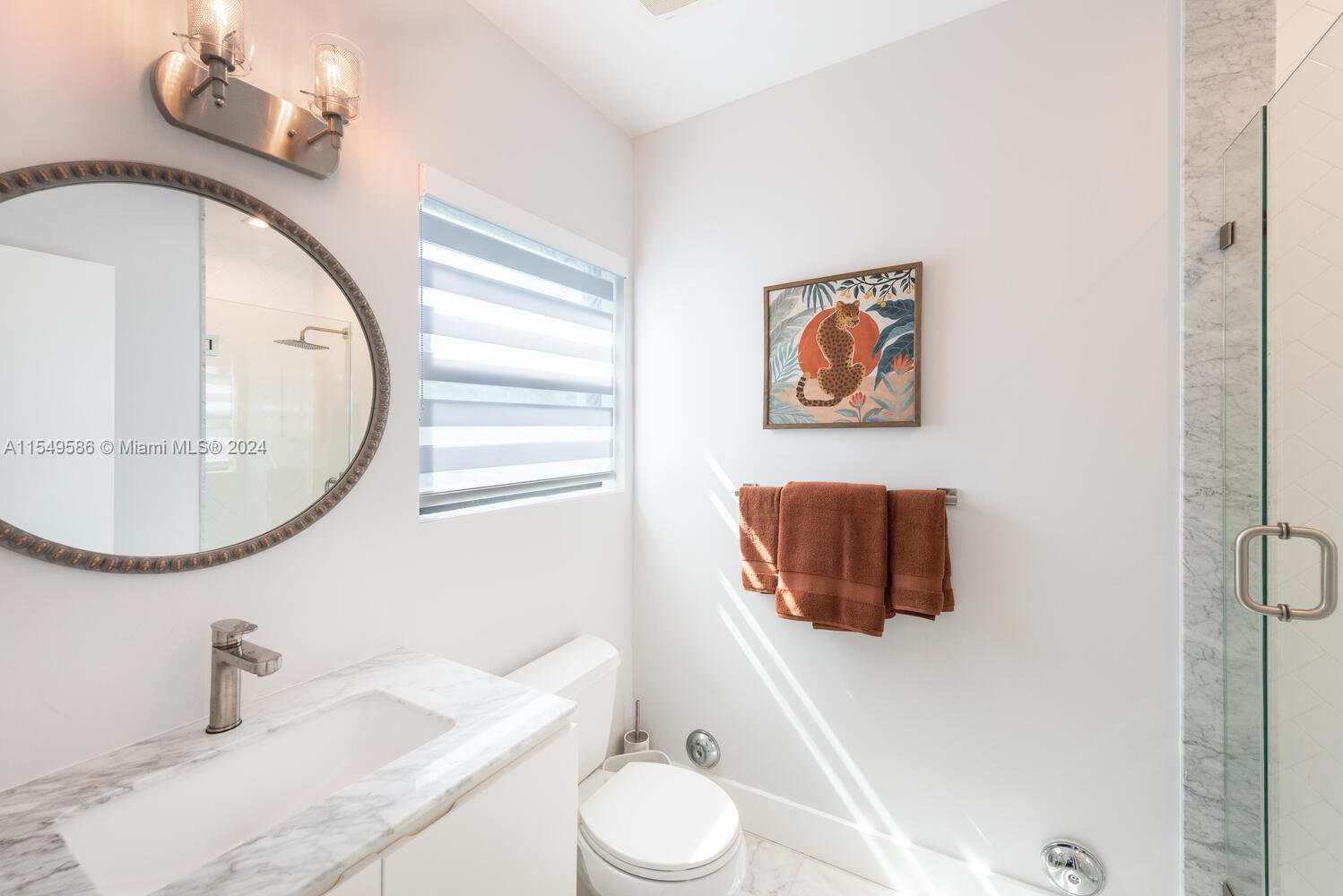 520 Southwest 27th Road Miami, FL 33129 - Photo 24 of 50 a bathroom with a toilet sink and mirror