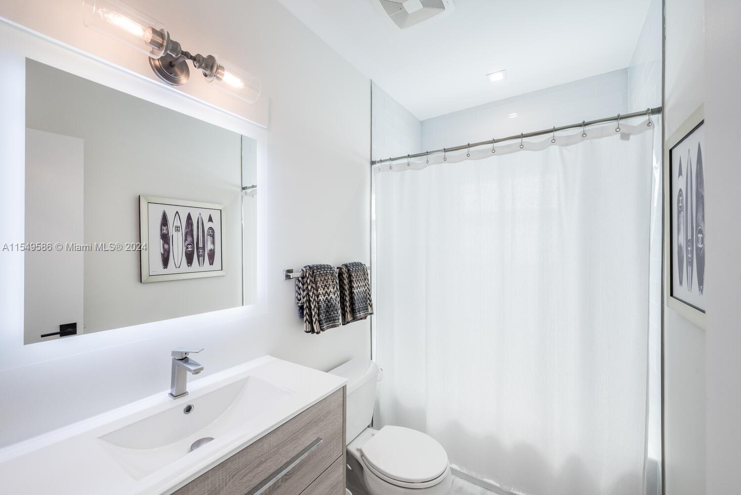 520 Southwest 27th Road Miami, FL 33129 - Photo 26 of 50 a bathroom with a sink toilet and vanity