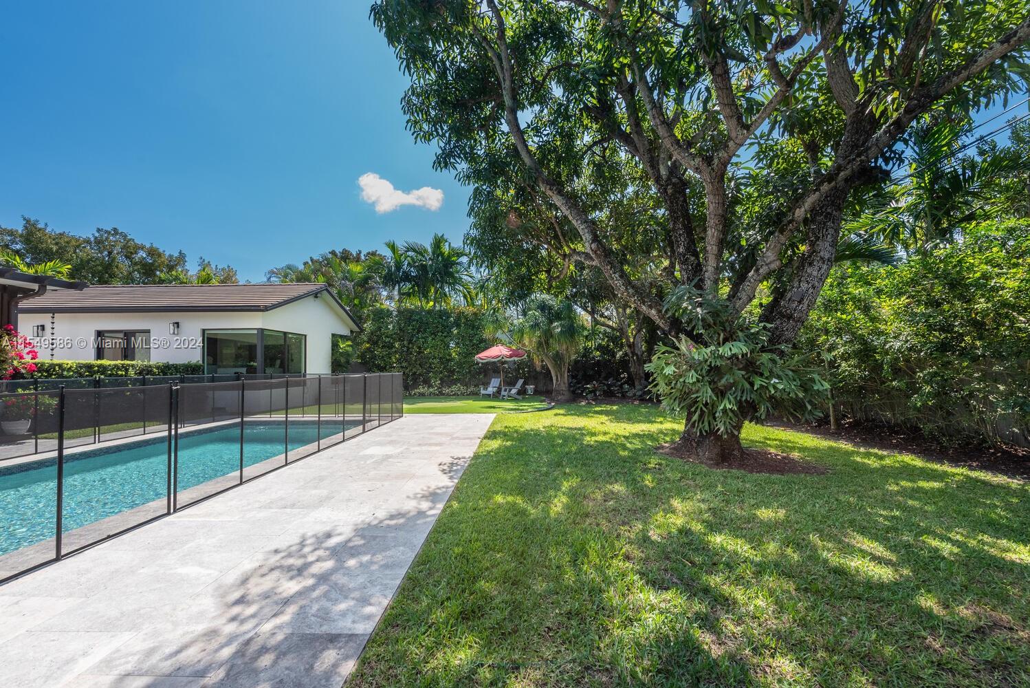 520 Southwest 27th Road Miami, FL 33129 - Photo 38 of 50 a view of a house with a yard and a large tree