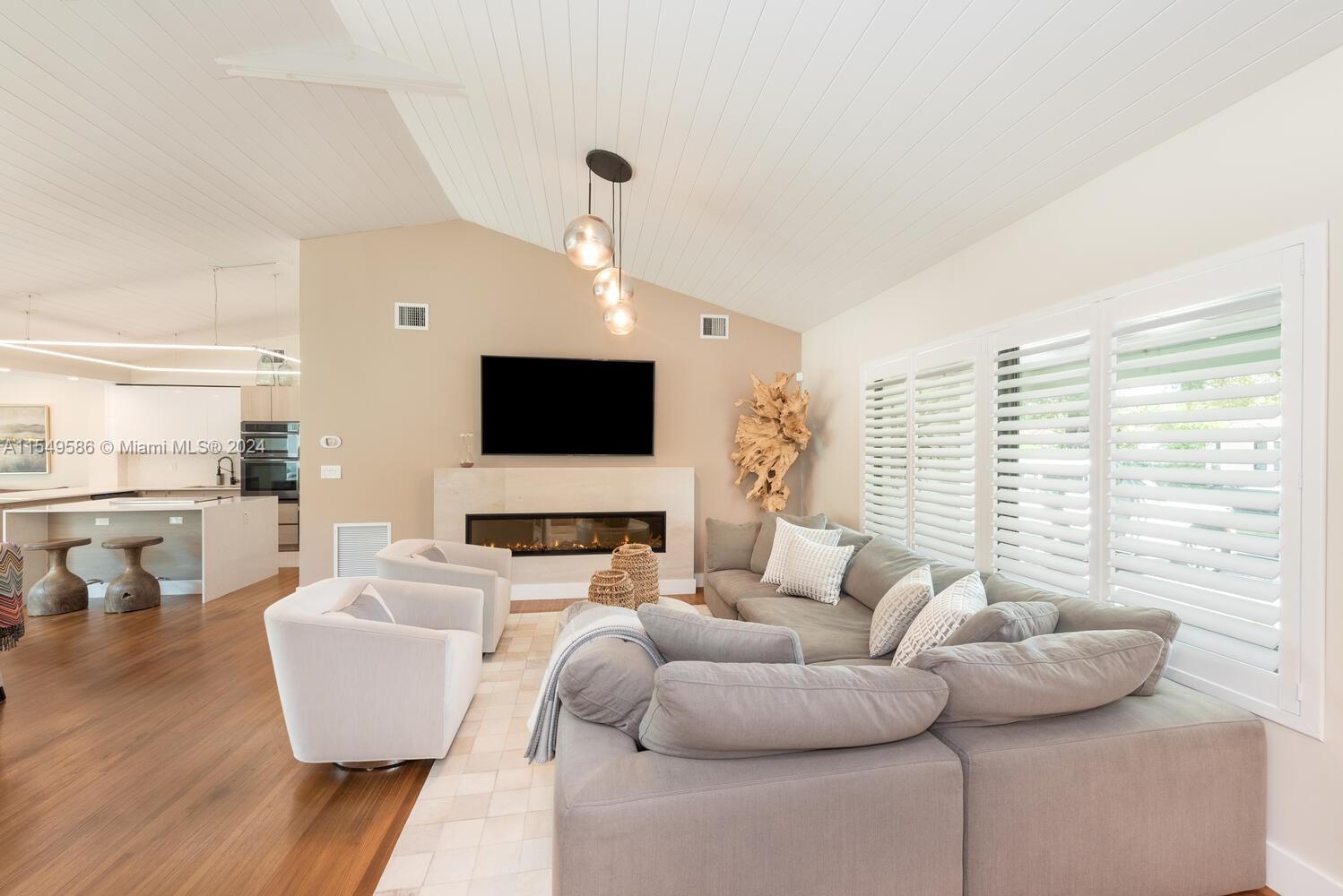 520 Southwest 27th Road Miami, FL 33129 - Photo 9 of 50 a living room with furniture and a flat screen tv