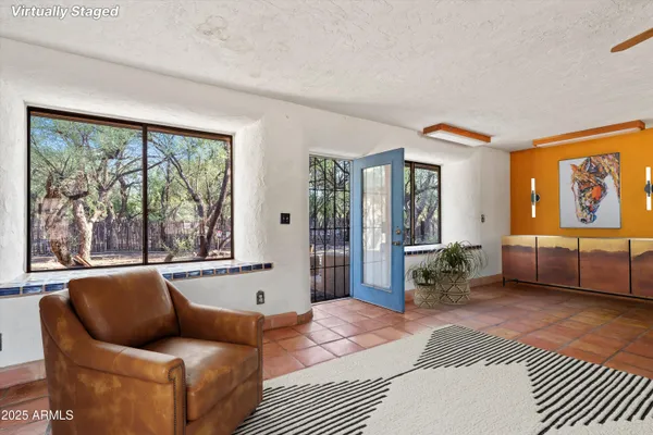 a view of a livingroom with furniture and a flat screen tv
