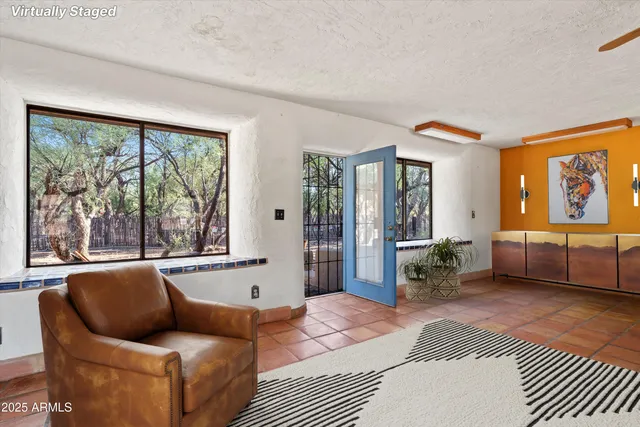 a view of a livingroom with furniture and a flat screen tv