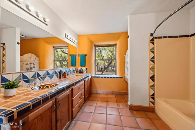 a kitchen with granite countertop a refrigerator sink and cabinets