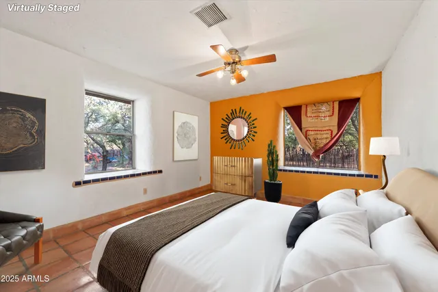 a bedroom with a bed and a painting on the wall